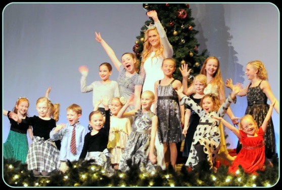 Miss Grand Forks 2013 Laura Harmon with community kids during the opening number of Christmas at the Empire 2012